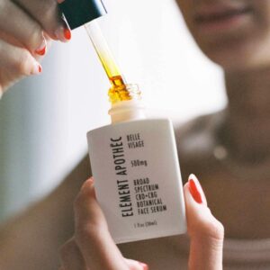 a beautiful young lady applying serum on her skin