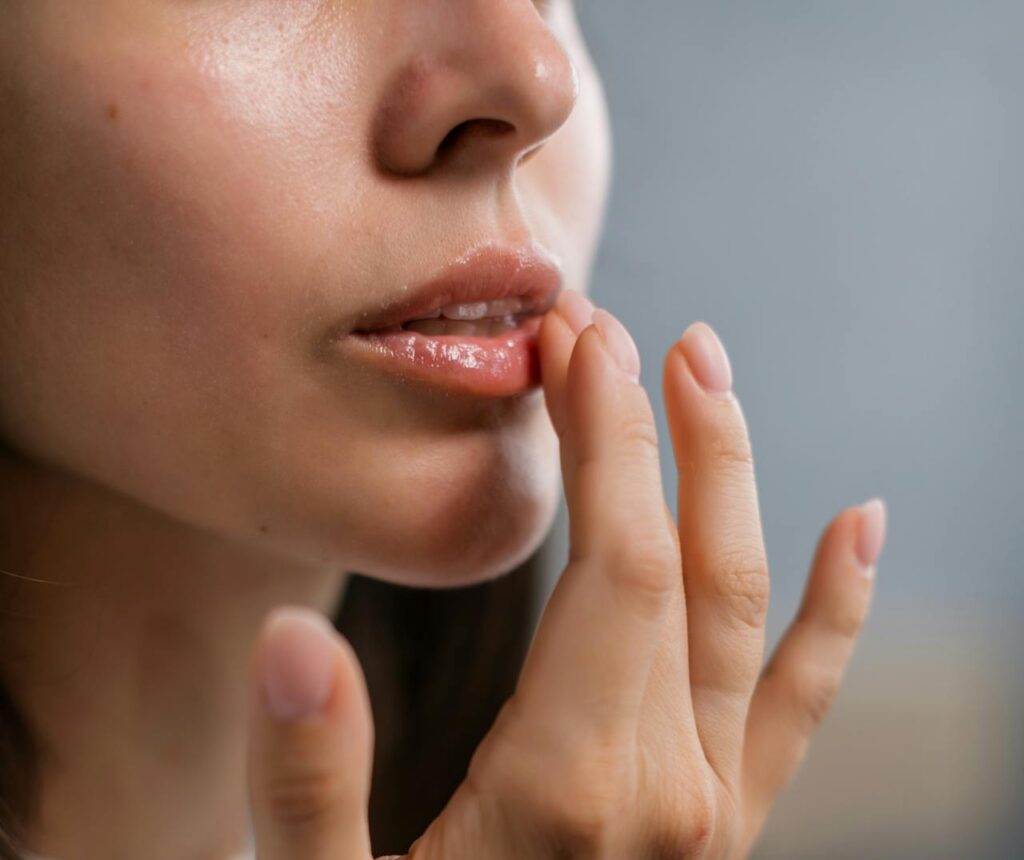 beautiful young lady applying lip balm