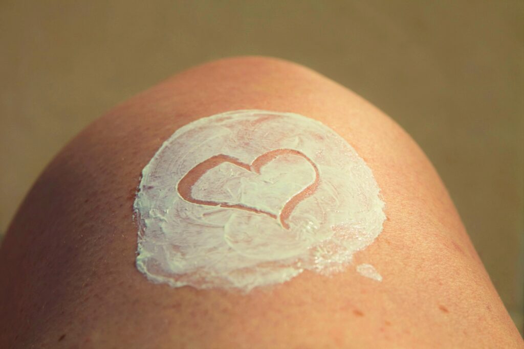 Heart-shaped skin cream application representing hydration and self-care